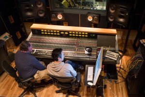 Studio owner Ken Krei and sound engineer Jon Chi at the Third Ward Records soundboard.